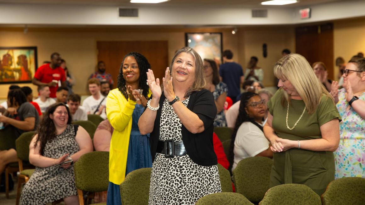 Dr. Kristine Blair claps during the steel drum performance at Juneteenth 2024.