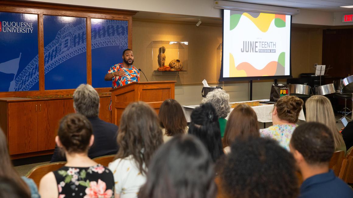 Quincy Stephenson gives a spoken word performance to the Juneteenth 2024 crowd.